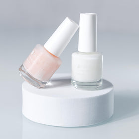 Dazzle Dry bottle with cap beside ruler conveying 0.5 oz size and portability