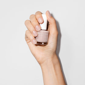 Dazzle Dry swatch on fingertips showing natural taupe finish benefit