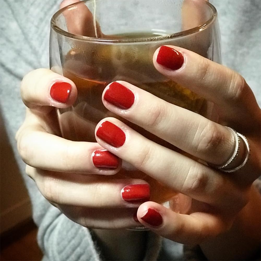 Dazzle Dry Rapid Red swatch on nail showing full-coverage cream finish