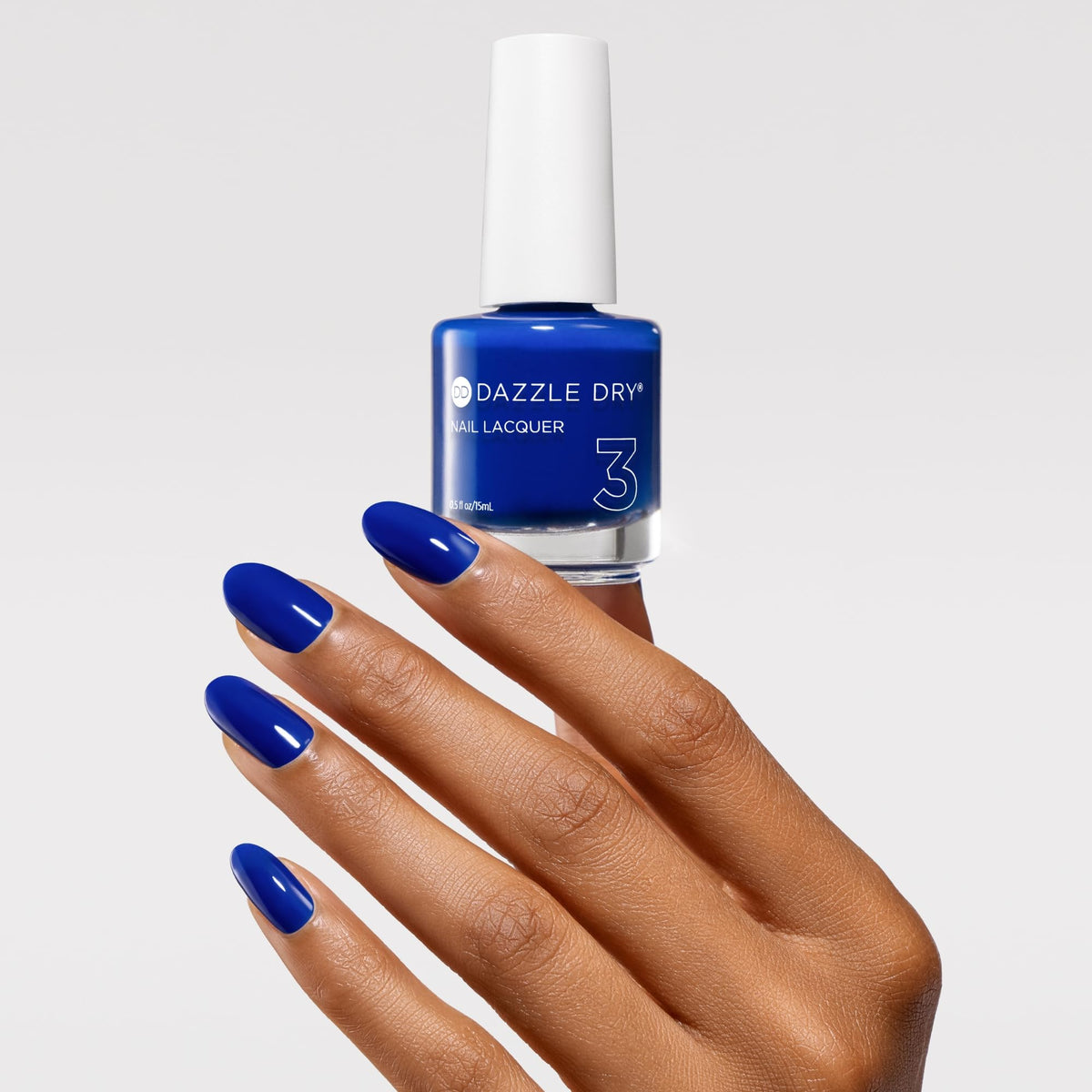 Dazzle Dry Saphira swatch on nail wheel showing true semi-sheer cobalt