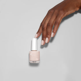 Dazzle Dry bottle held in hand illustrating 0.5 fl oz size and travel-friendly convenience