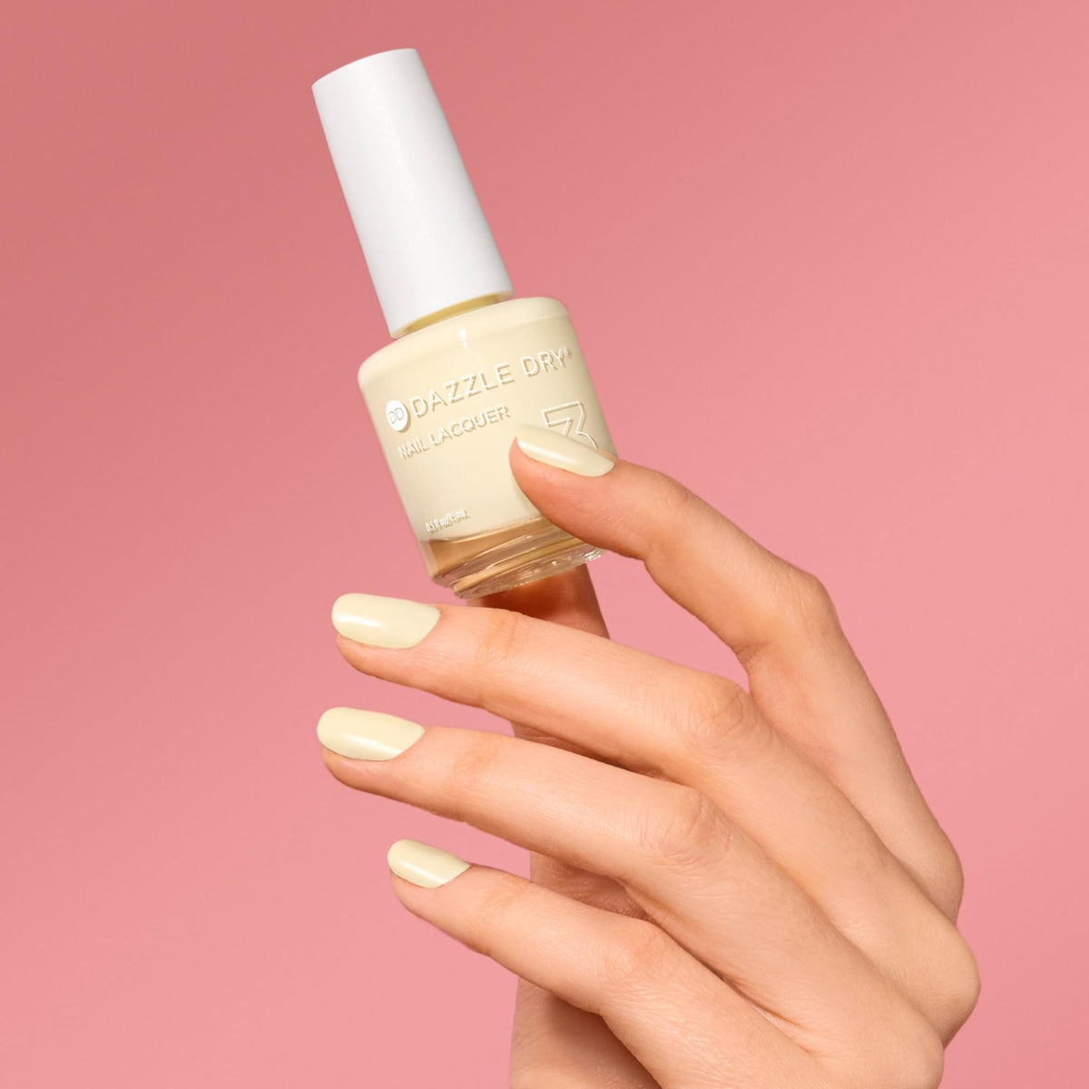Dazzle Dry painted nails with Sundress on hand showing soft yellow tone