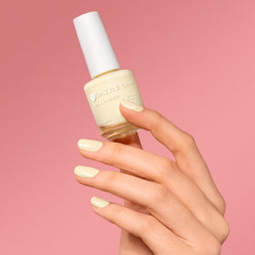 Dazzle Dry painted nails with Sundress on hand showing soft yellow tone