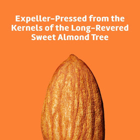 De La Cruz almond oil next to common objects showing 8 fl oz scale benefit