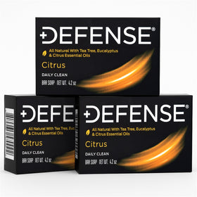 Defense Soap citrus bar in hand size comparison showing portable weight and convenience