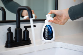 Defense Soap used during hand washing, demonstrating proper cleansing in communal spaces