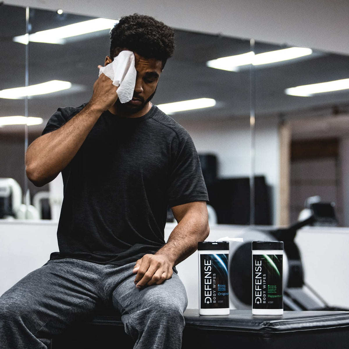 Athlete wiping neck with Defense Soap wipes for immediate cooling relief