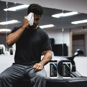 Athlete wiping neck with Defense Soap wipes for immediate cooling relief