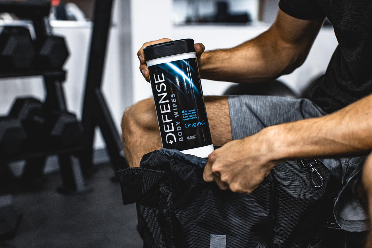 Defense Soap wipe cleaning gym equipment and reducing grime