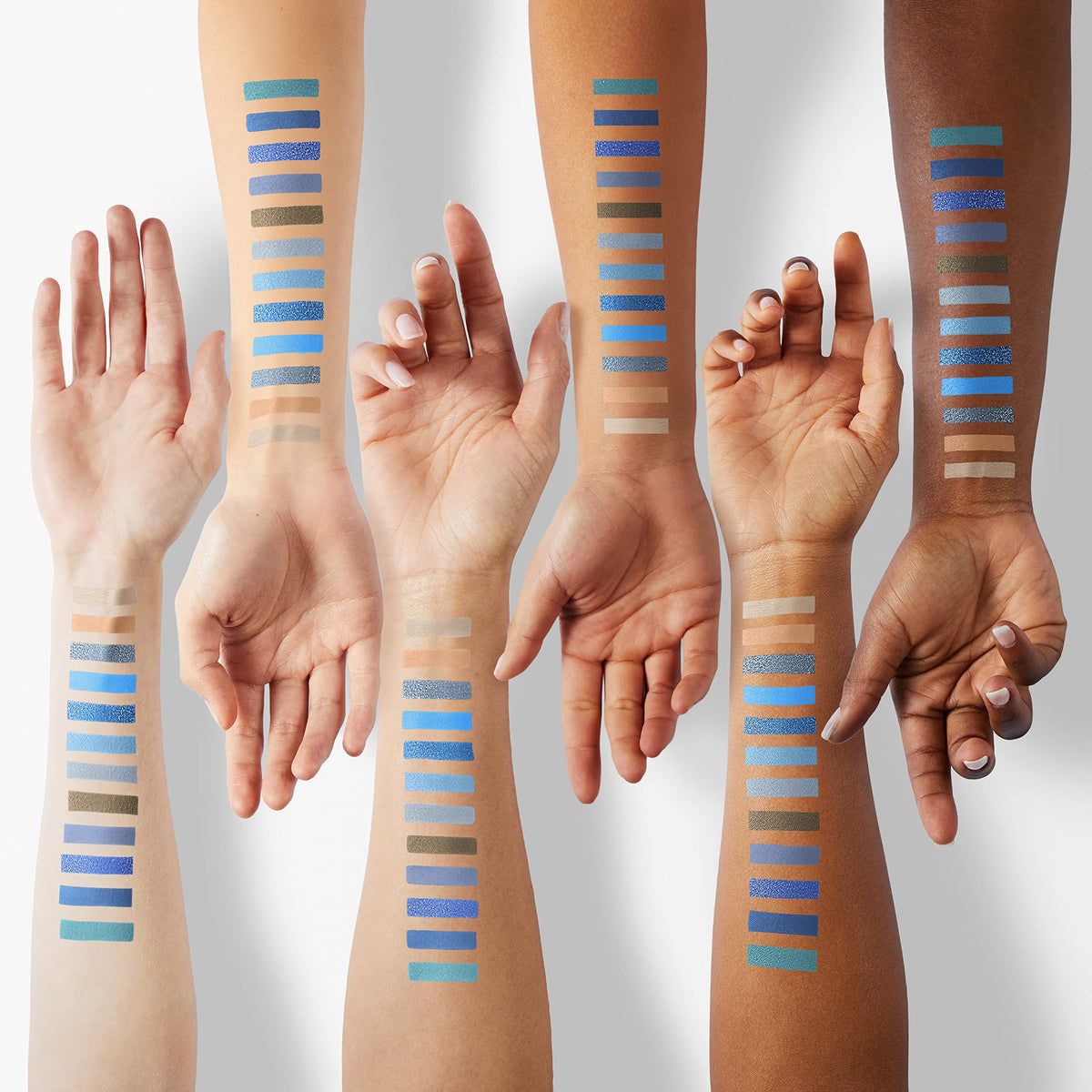 DE'LANCI swatches on arm showing strong pigment payoff and blendable finish