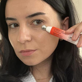 Derma E applying product under eye showing targeted treatment and cooling benefit