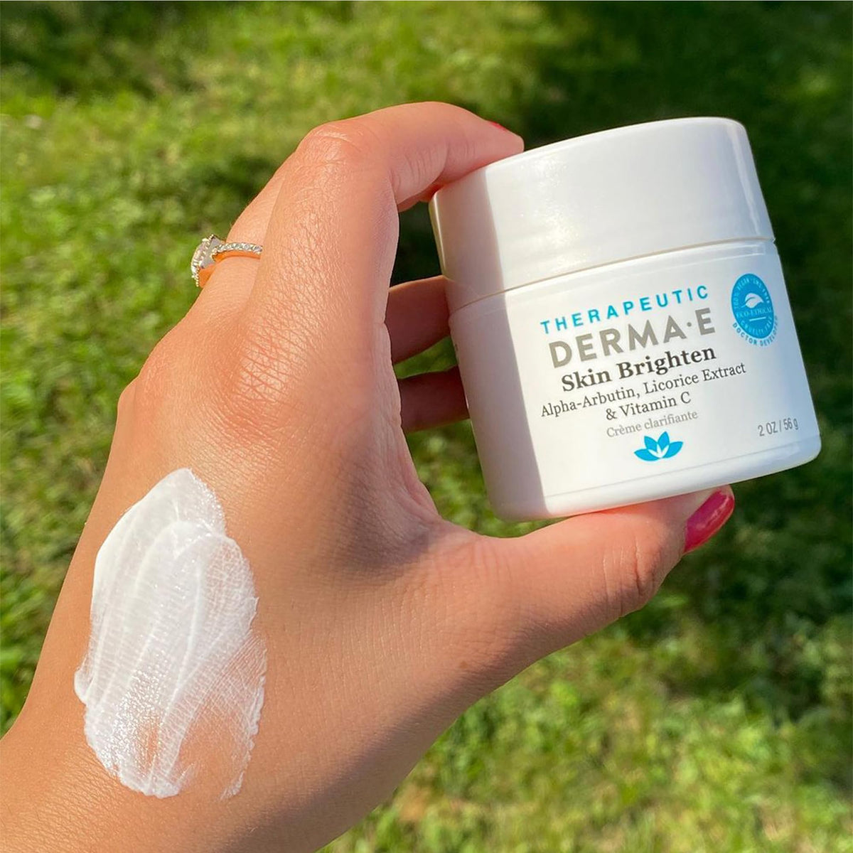 Derma E 2 oz jar in hand showing size and travel-friendly benefit