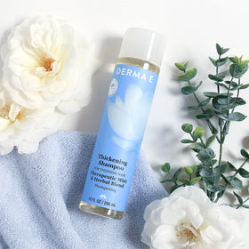 Derma E bottle on bath shelf showing clean-beauty packaging and routine-friendly benefit