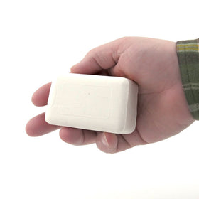 Dermaharmony lathered bar in hand demonstrating rich foam and gentle cleansing action