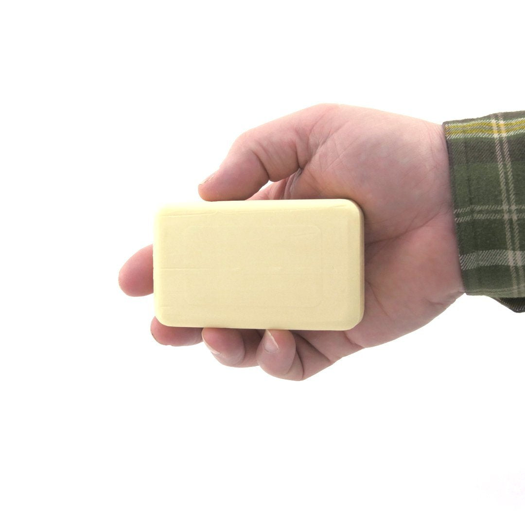 DermaHarmony bar beside a ruler for size comparison showing two travel-friendly 3.7 oz bars for portability