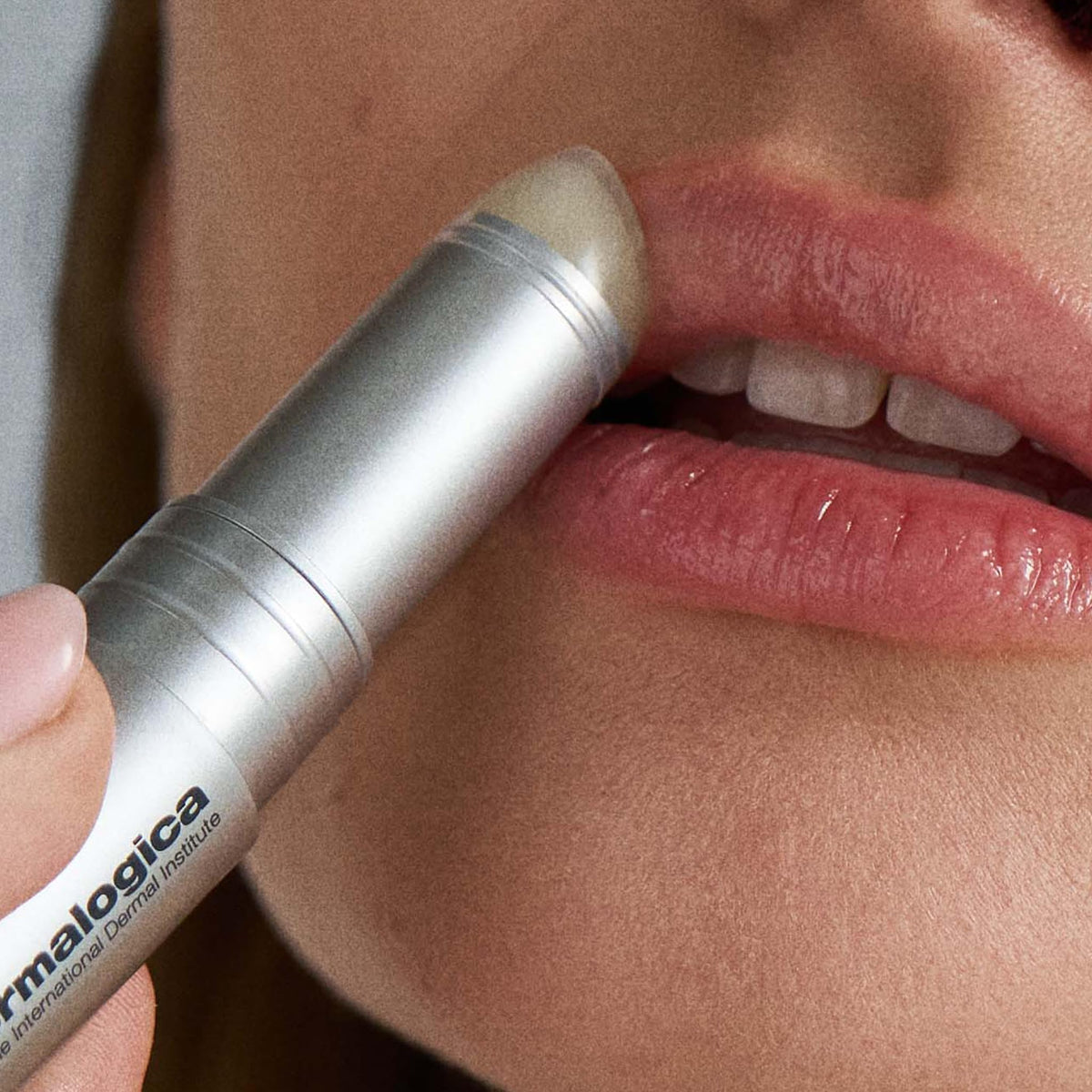 Dermalogica size scale next to fingers shows travel-friendly, concentrated treatment