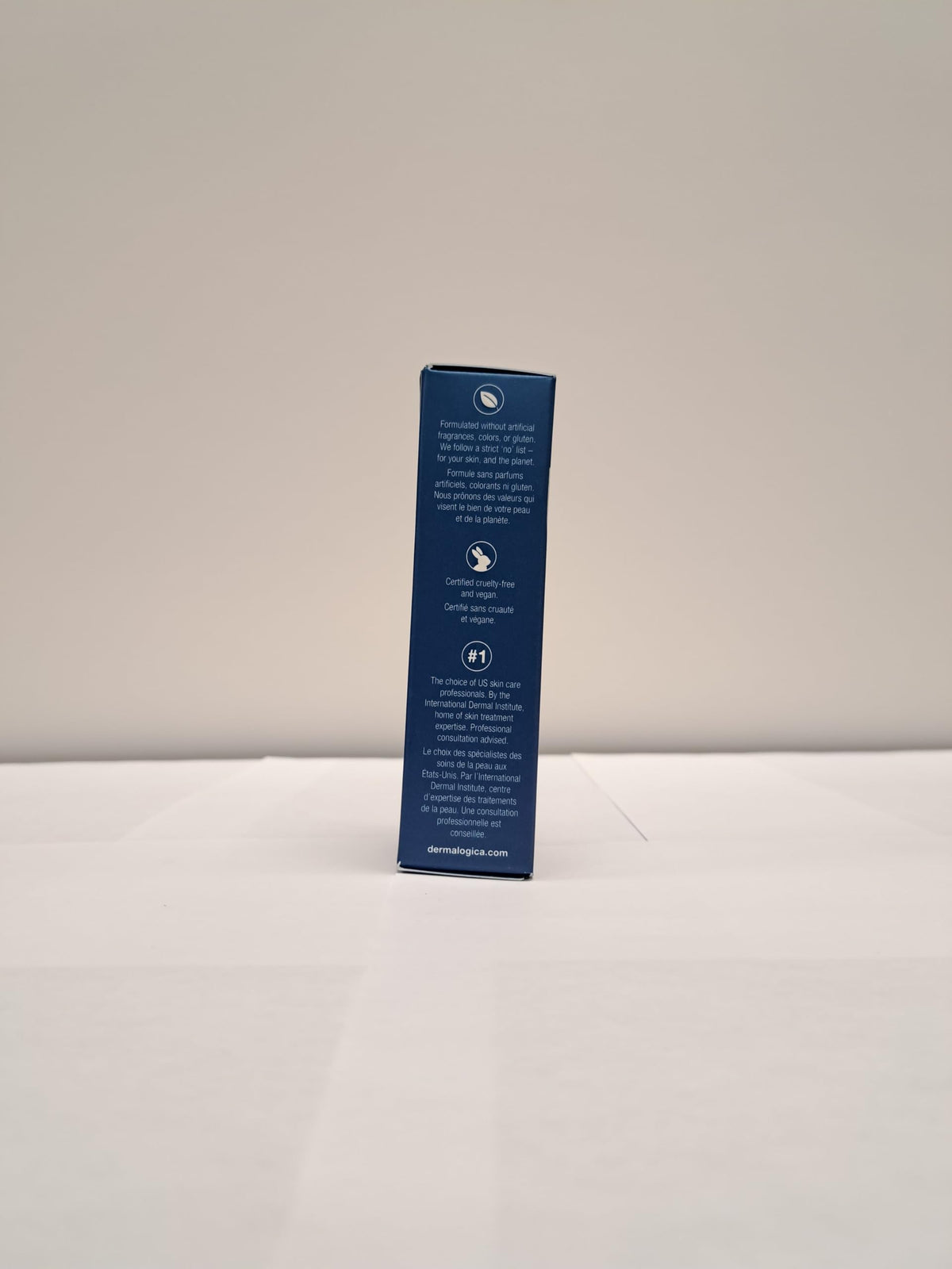 Dermalogica jar next to coin showing small 0.5 fl oz size for portability benefit