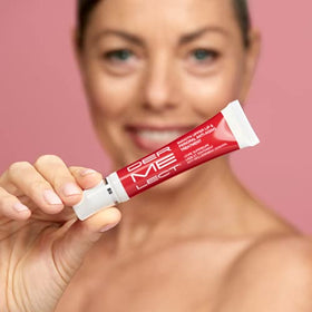 Dermelect label close-up listing peptides and arbutin for brighter, firmer skin