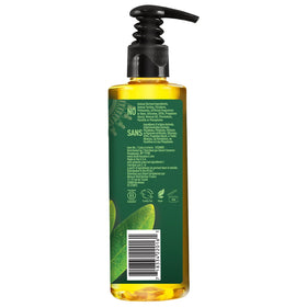 Desert Essence bottle held in hand for size and portability