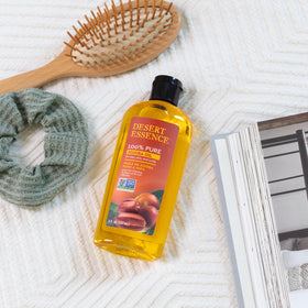 Desert Essence oil on hand demonstrating quick absorption and non-greasy benefit