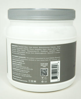 Design Essentials conditioner in use detangling curly hair for smoother styling