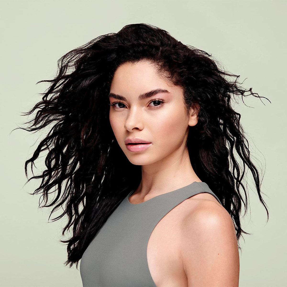 DevaCurl foam being dispensed in hand for easy application benefit