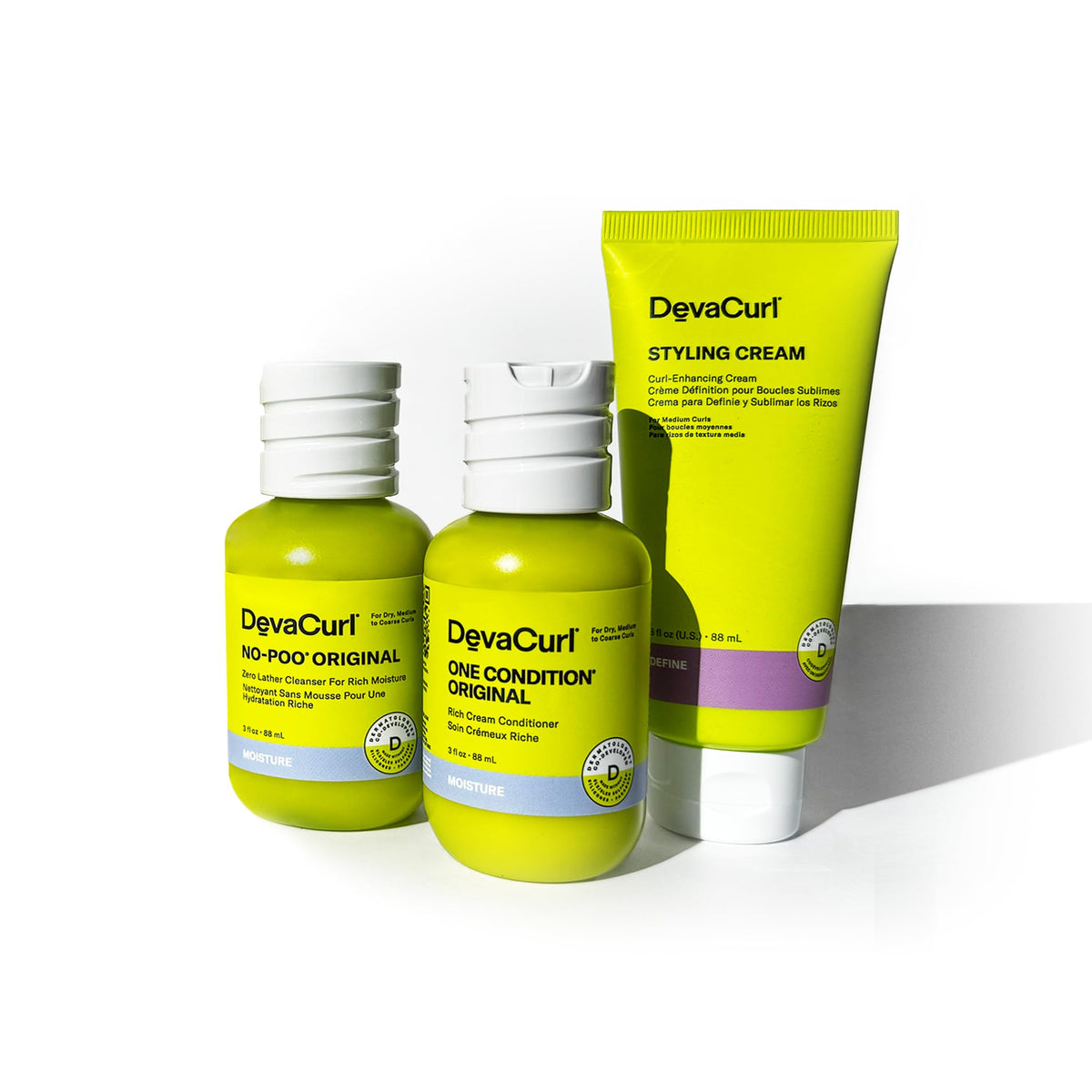 DevaCurl OG Kit in hand for travel-scale comparison and portable convenience