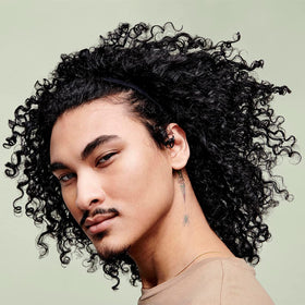 DevaCurl before and after in hair showing improved curl definition and reduced frizz