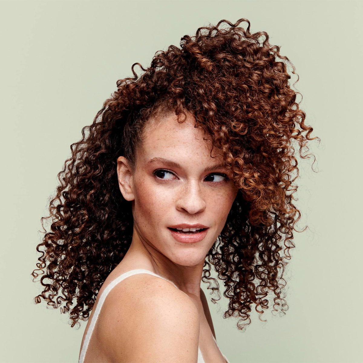 DevaCurl Low-Poo foam texture illustrating mild lather for gentle cleansing