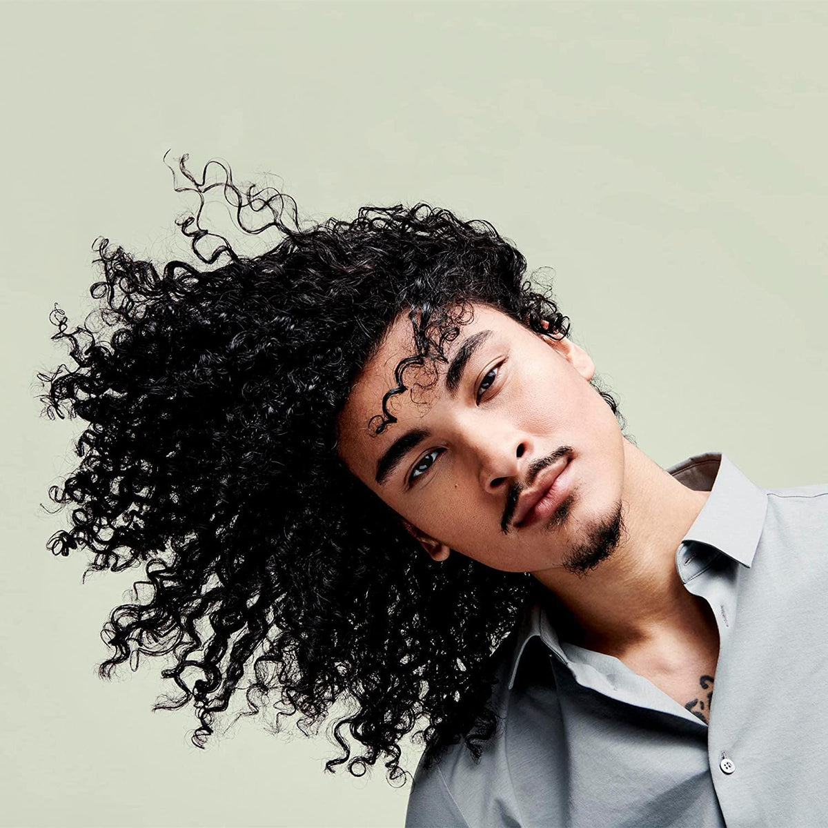 DevaCurl being spritzed on curly hair for refreshed definition and shine