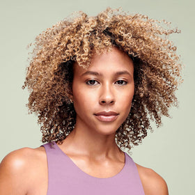 DevaCurl product droplet on hand showing lightweight texture and hydration