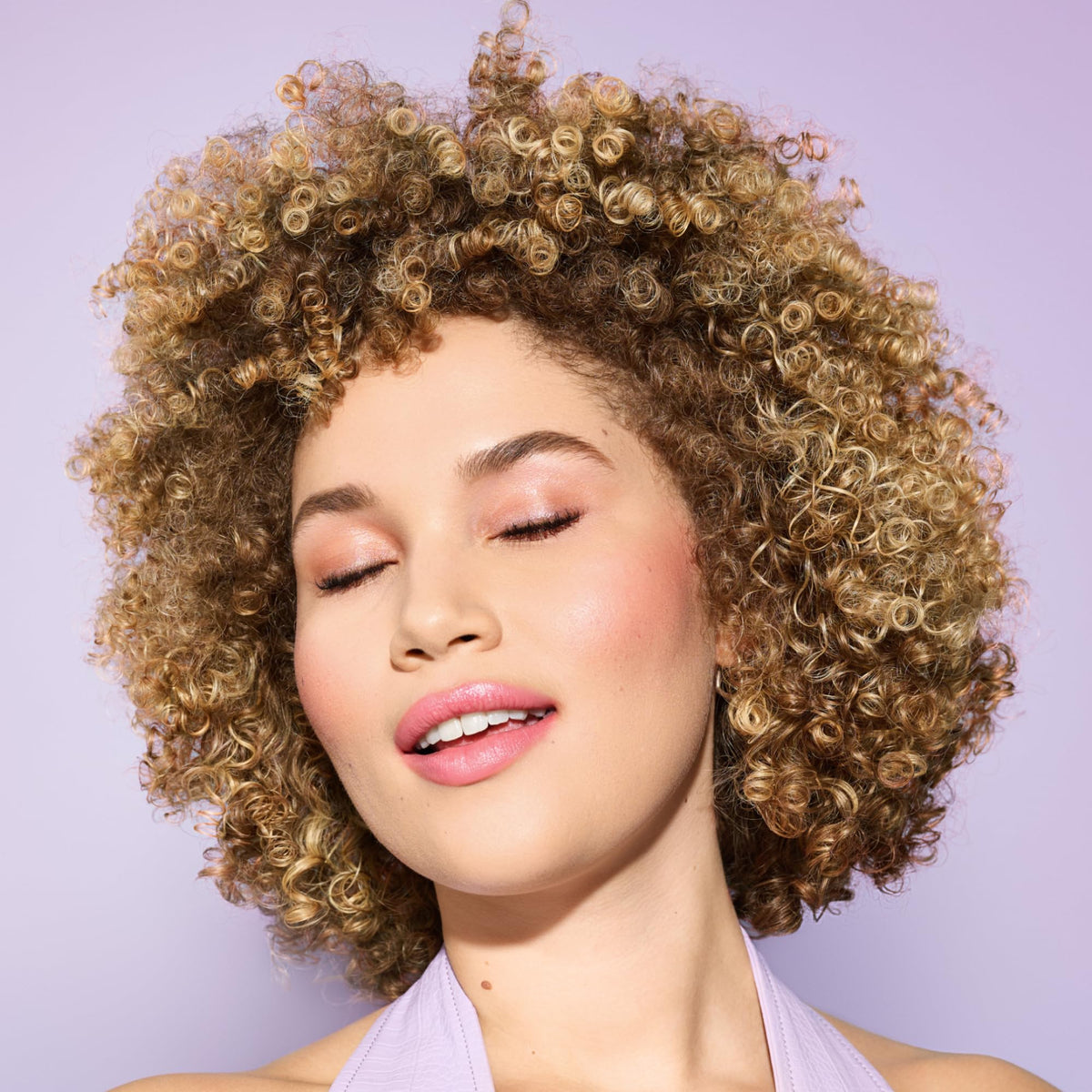 DevaCurl clear gel texture in hand showing non-sticky, smooth formula for easy styling