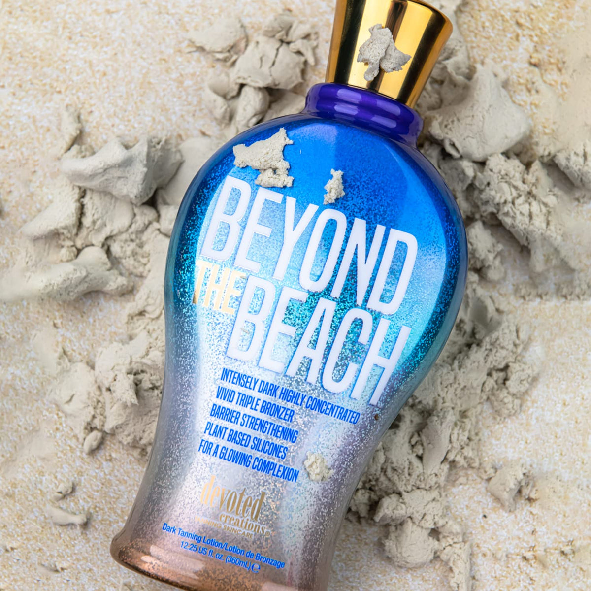 Devoted Creations in beach bag flatlay suggesting travel-ready size and luminous tan results