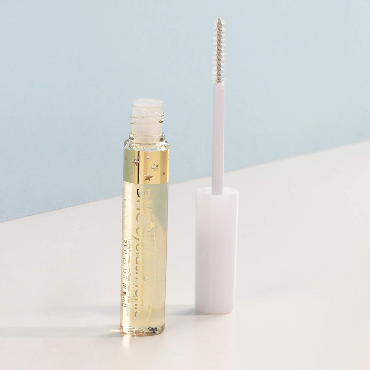 DHC eyelash tonic being applied to lash base showing easy daily use