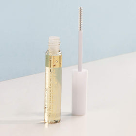 DHC eyelash tonic being applied to lash base showing easy daily use