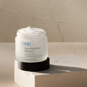 Close-up of DHC label listing key ingredients and fragrance-free benefit