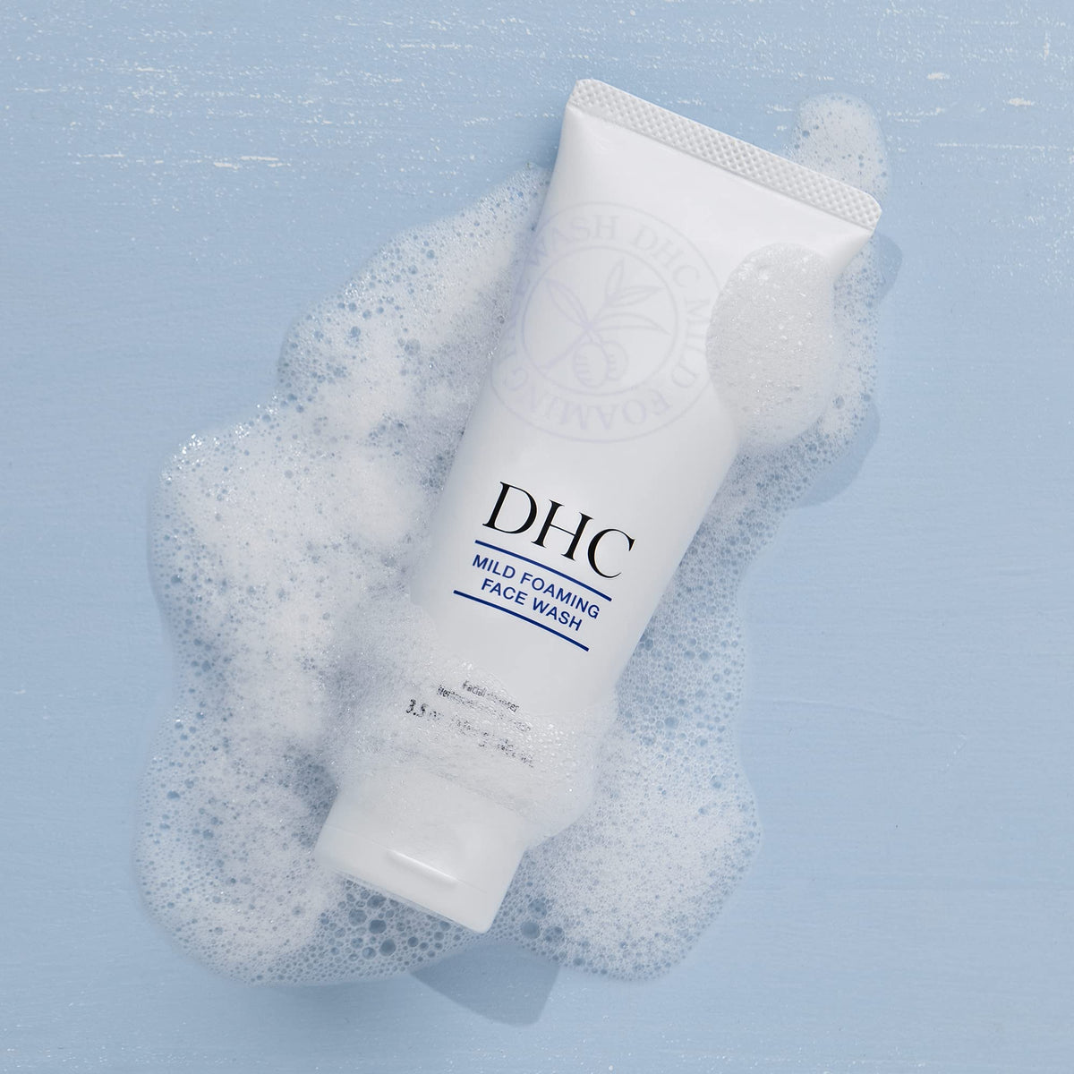 DHC foamy cleanser rinsing off face with water showing residue-free finish