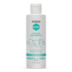DHS clear shampoo bottle front view showing clean unscented packaging and gentle formula benefit