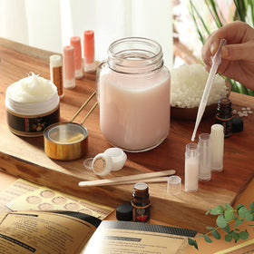 DilaBee pouring warm balm into tube demonstrating easy heat-and-pour