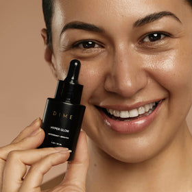 DIME serum in bathroom routine showing layering under makeup benefit