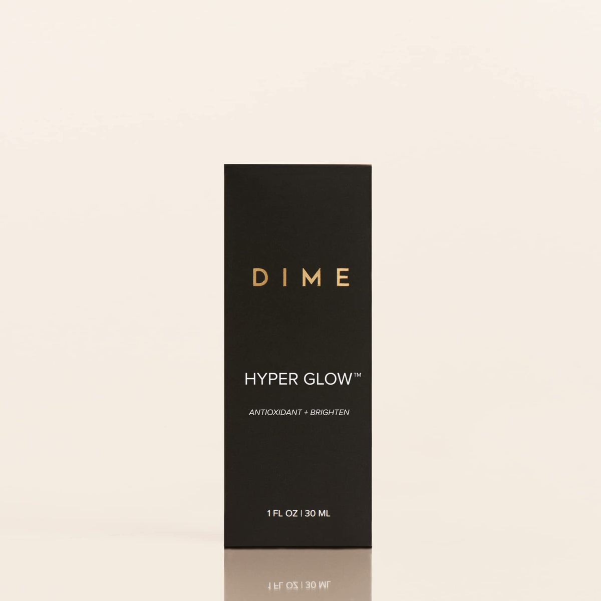 DIME bottle held in hand for scale showing compact travel-friendly benefit