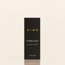 DIME bottle held in hand for scale showing compact travel-friendly benefit