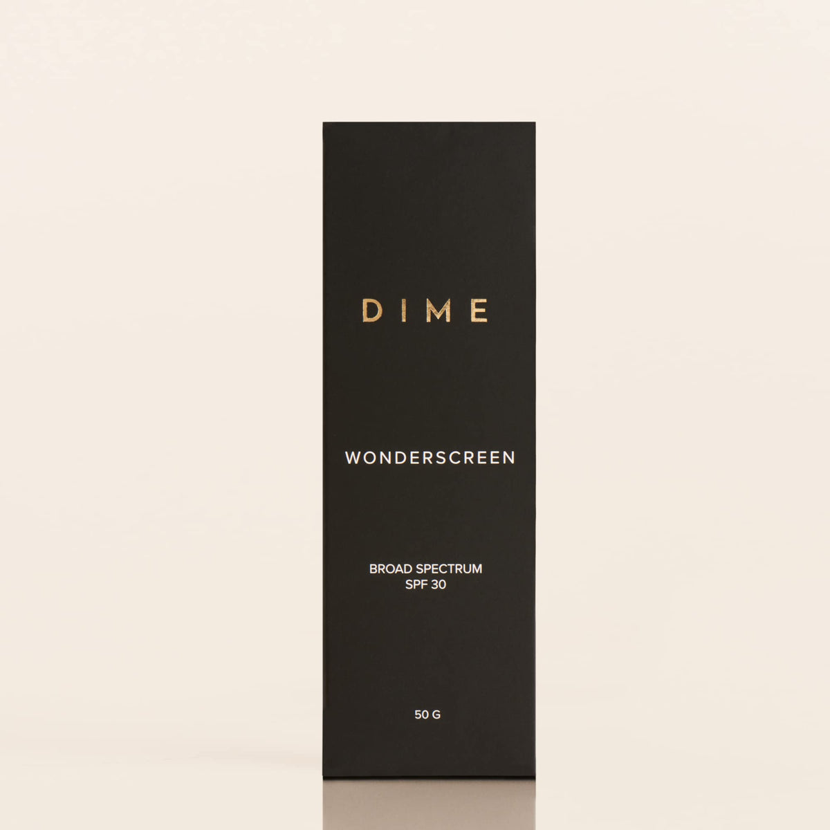 DIME Wonderscreen next to a coin to show 50g scale and convenient sizing benefit