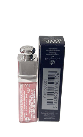 Dior Addict lip maximizer beside a coin for scale highlighting the small 2 ml travel size