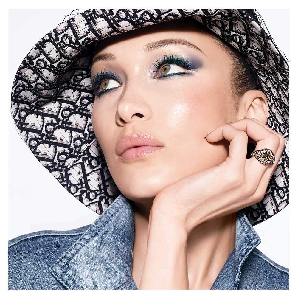 Dior tube in hand to show compact 0.21 oz size and portability
