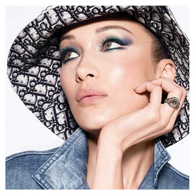 Dior tube in hand to show compact 0.21 oz size and portability