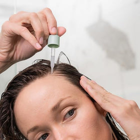 divi scalp serum on bathroom shelf lifestyle scene suggesting routine-ready product