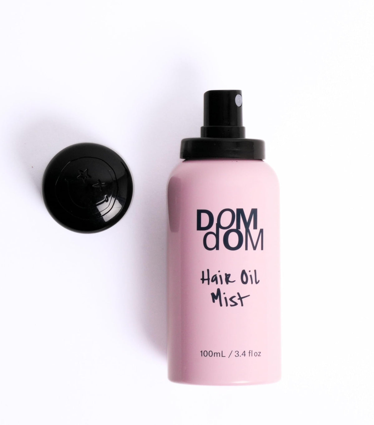 Dom Dom in use on damp hair smoothing frizz and sealing moisture
