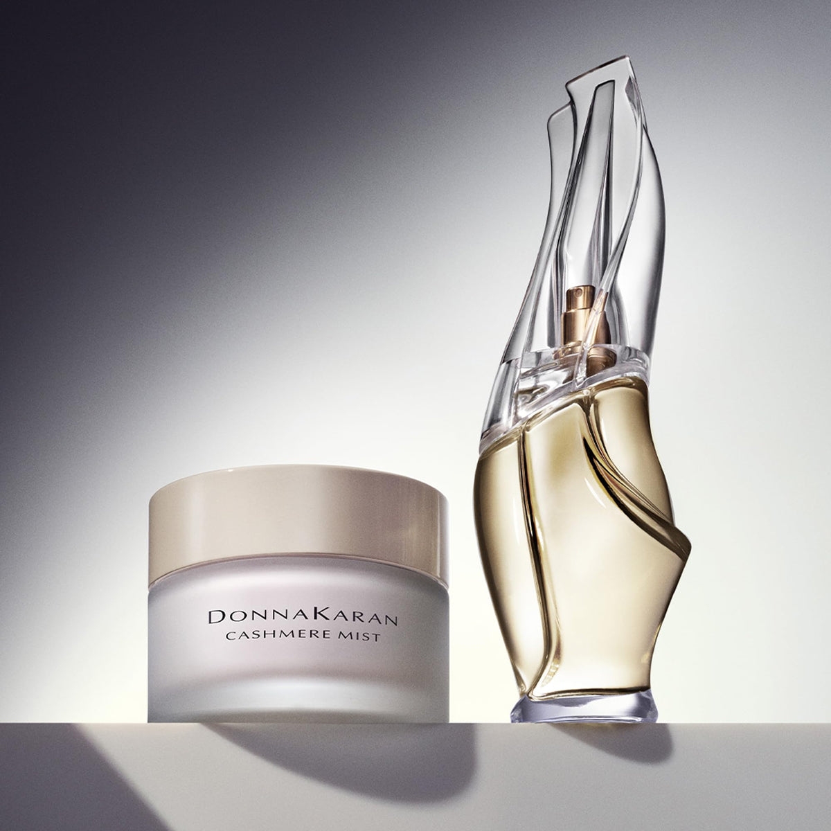 Donna Karan Cashmere Mist applied to hand illustrating soft hydrated skin benefit