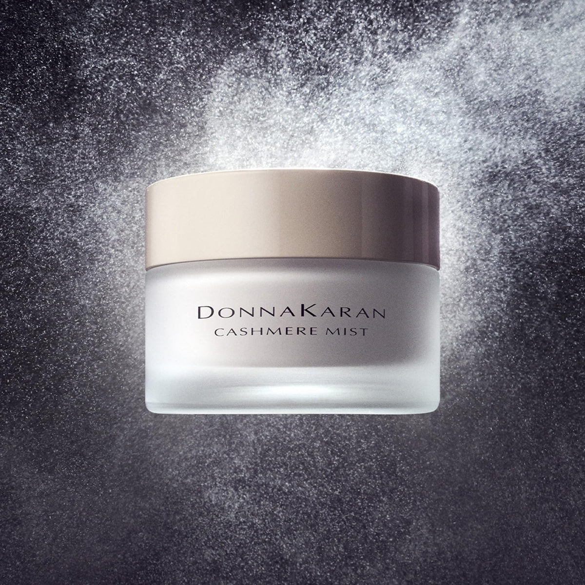 Donna Karan Cashmere Mist crème being dolloped to demonstrate smooth spreadability